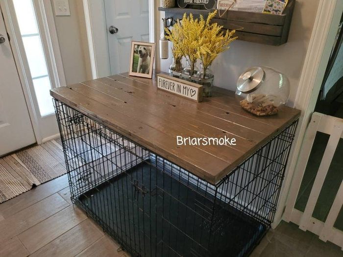 a dog kennel featuring a wooden panel on top