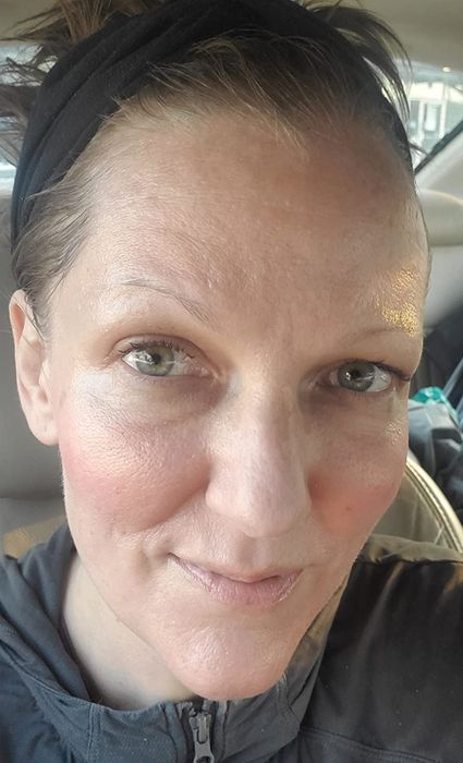 image of reviewer applying sunscreen on their face