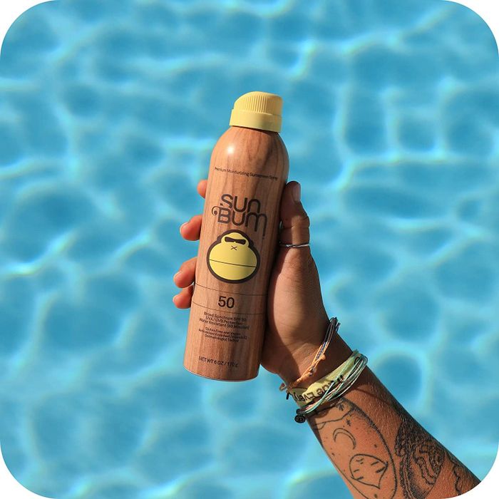 a hand holding the sunscreen bottle
