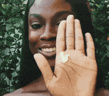 A model demonstrating how the sunscreen doesn't leave a white cast when applied.
