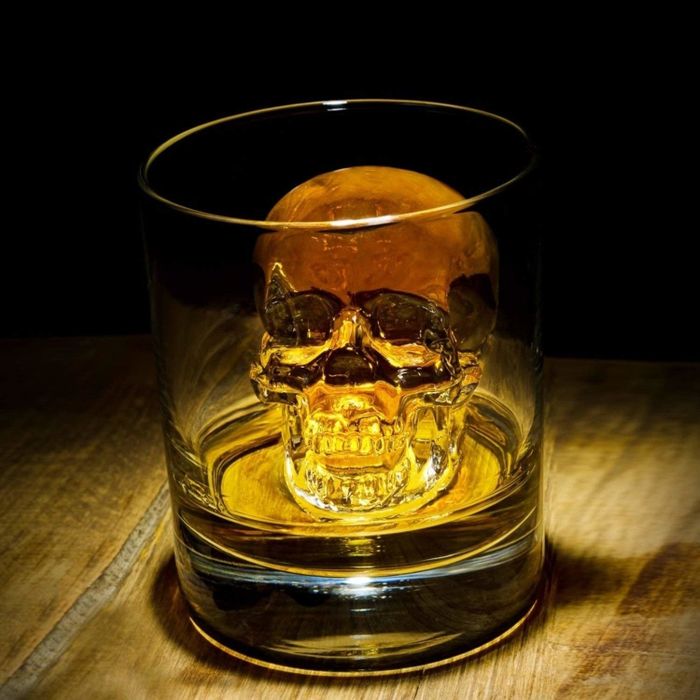The skull-shaped ice cube sitting in a rocks glass