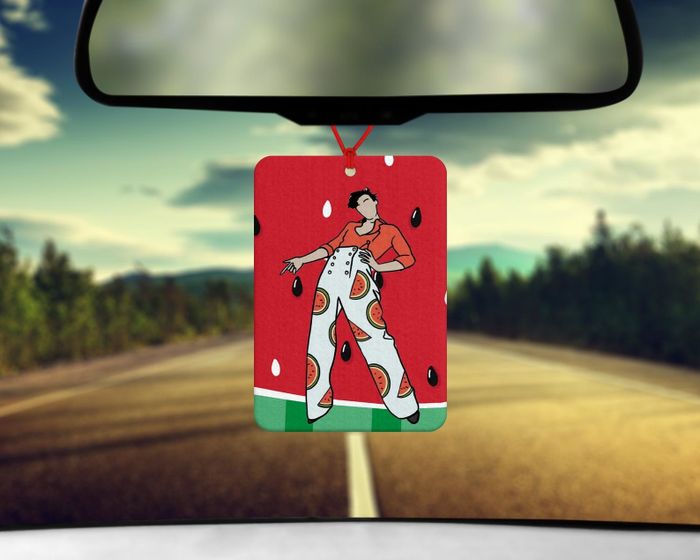 The air freshener featuring an illustration of Harry Styles set against a vibrant watermelon background.