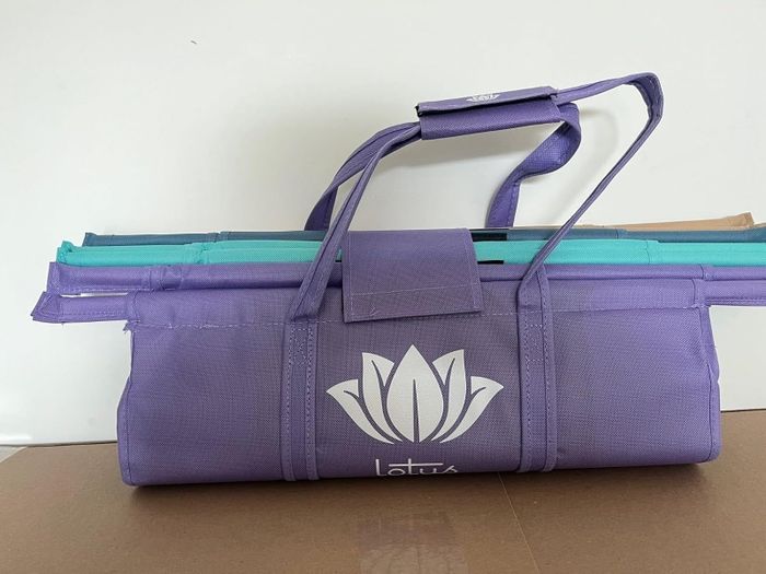 Reusable shopping bags with a lotus design that fold neatly into a compact case for easy carrying.