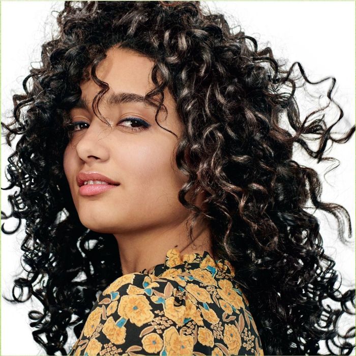 a model with shiny curly hair