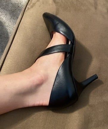 A reviewer wearing the black strappy heels.