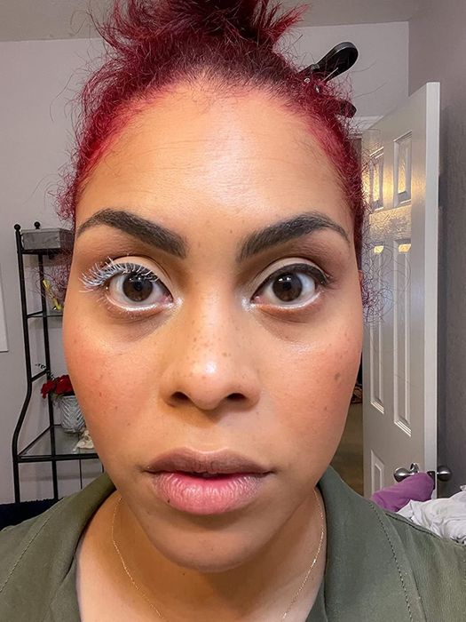 A reviewer with the white lash primer applied to one eye.