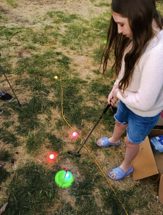 A reviewer enjoying their time playing with the mini-golf set.