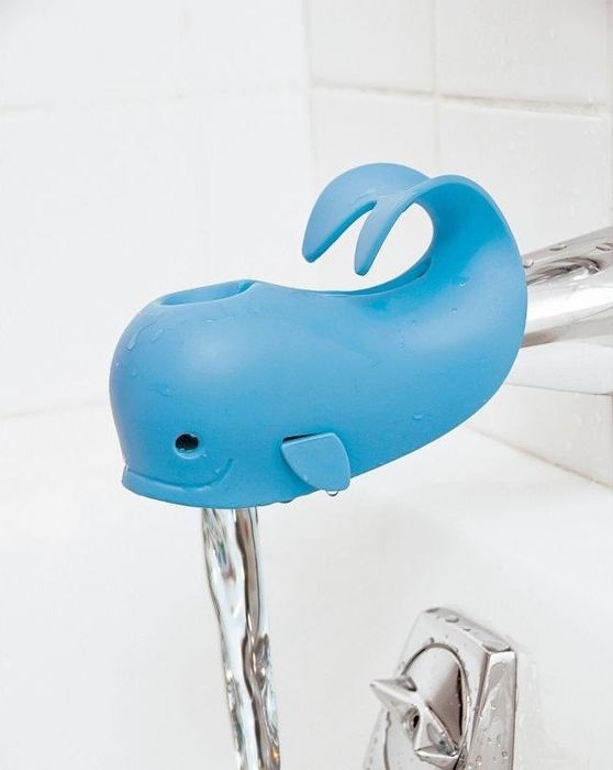 A whale-shaped spout cover fitted over a bath faucet.
