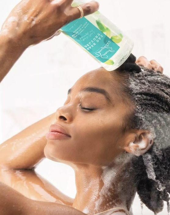 A person using a water to foam shampoo