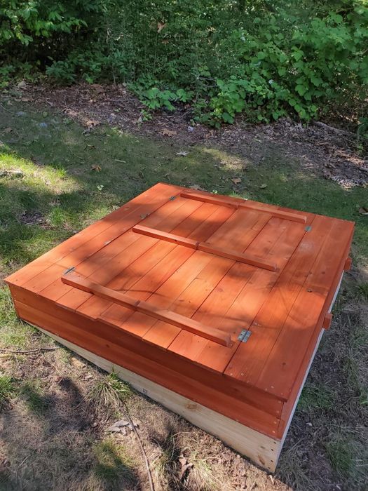 an outdoor sandbox with the lid securely closed