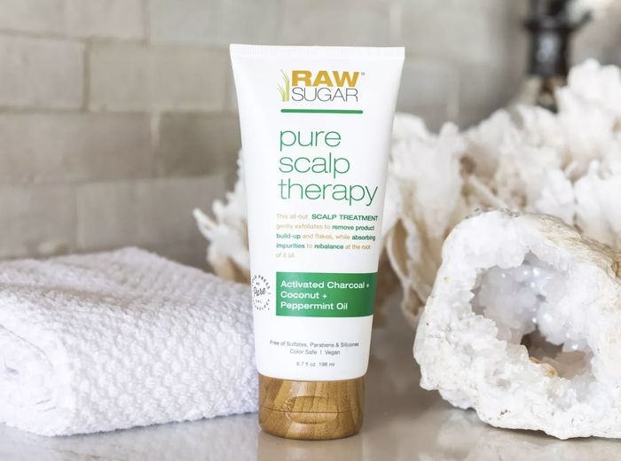 A tube of scalp treatment and a bath towel