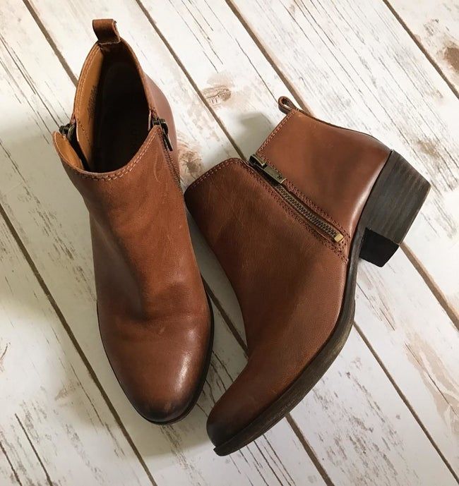 A reviewer's photo showing the brown faux leather booties.