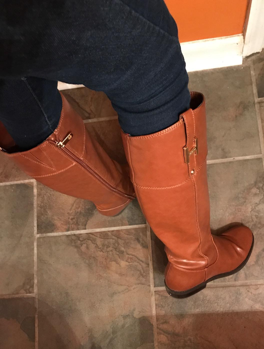 A close-up shot of the cognac boots adorning the reviewer's feet.