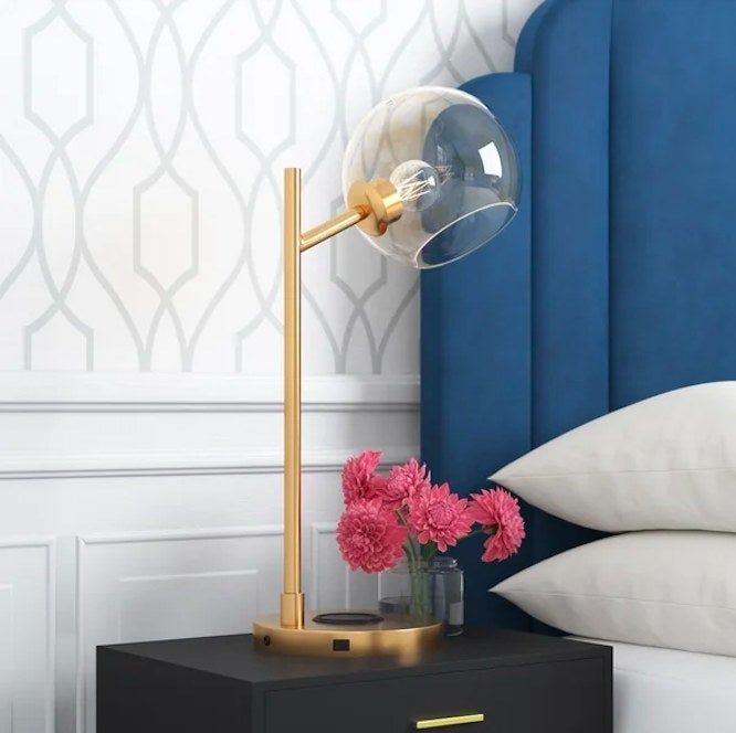 Lamp on a nightstand, adding a touch of elegance to the room.