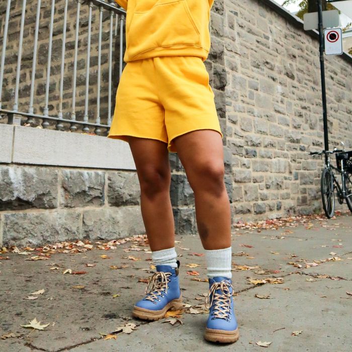 Model showcasing the shoes in a rich indigo color.