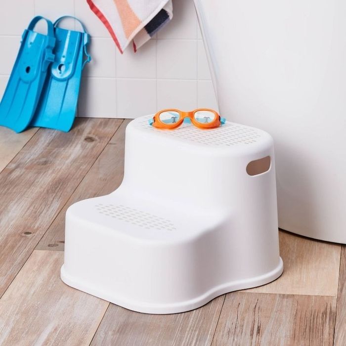A step stool placed in a bathroom