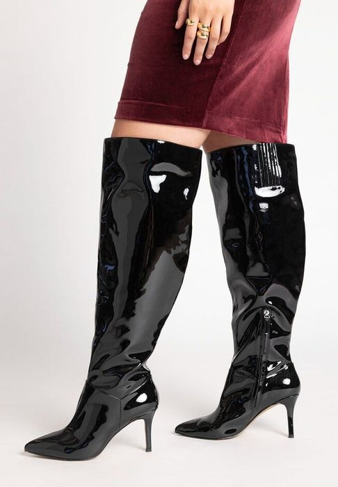 model showcasing the black metallic boots