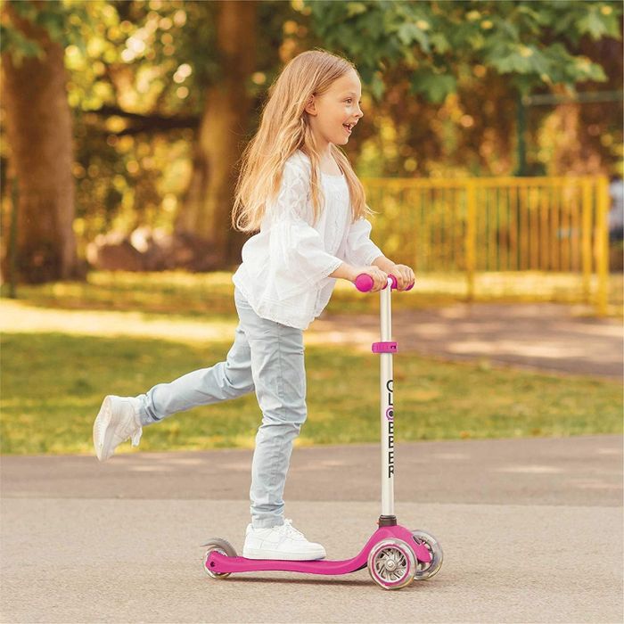 An older child riding the same scooter on their own
