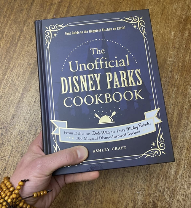 A customer review photo showing someone holding a copy of the book.