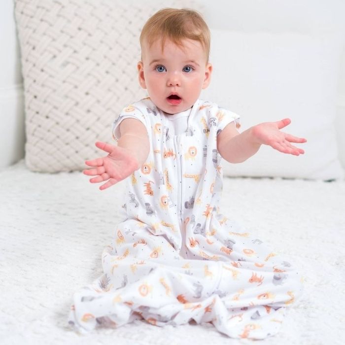 A baby model wears a wearable blanket.