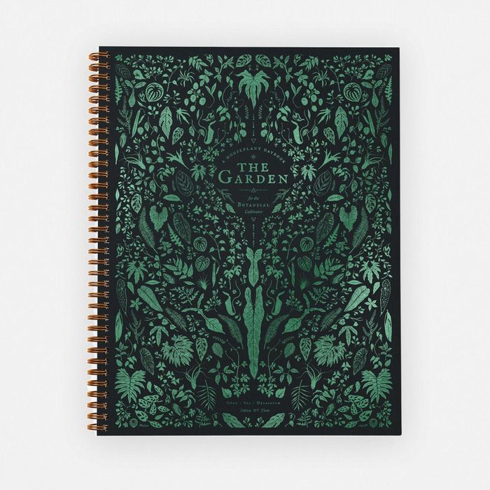 A botanical journal with a floral print and green cover.