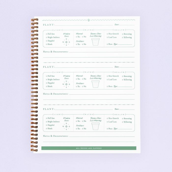 The pages of a botanical journal featuring a template for tracking plant care.