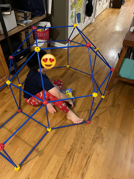 A reviewer's child sitting inside an igloo-shaped fort