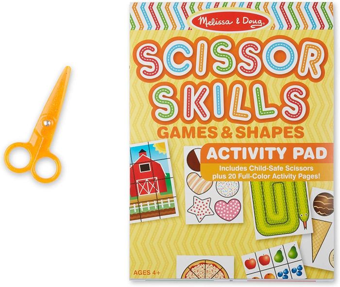 A pair of yellow scissors with an activity pad