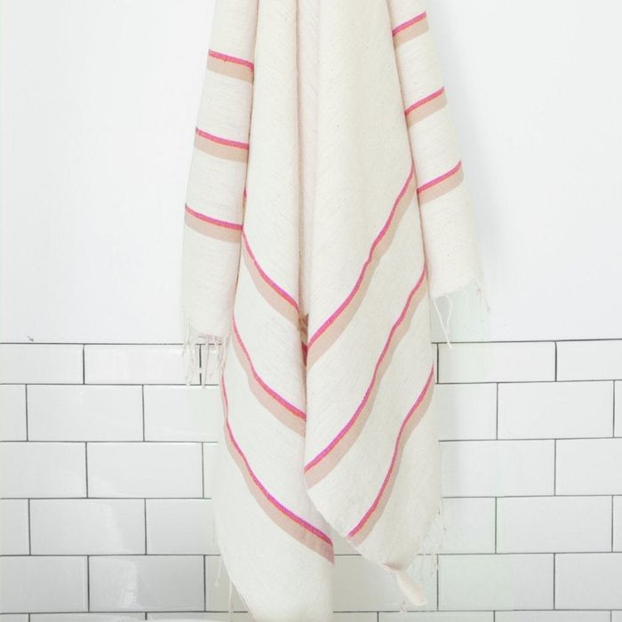 A white towel adorned with blue and beige stripes.