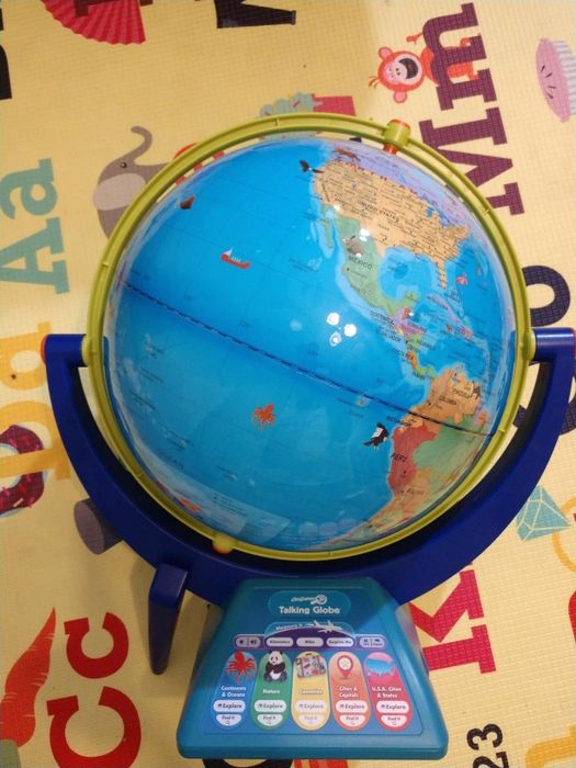 Interactive talking globe placed on a colorful alphabet-themed playmat, with various educational buttons to learn geography