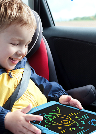 A child actively working on the LCD writing tablet.