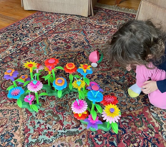 Another reviewer's child having fun playing with the bright, colorful plastic flowers.