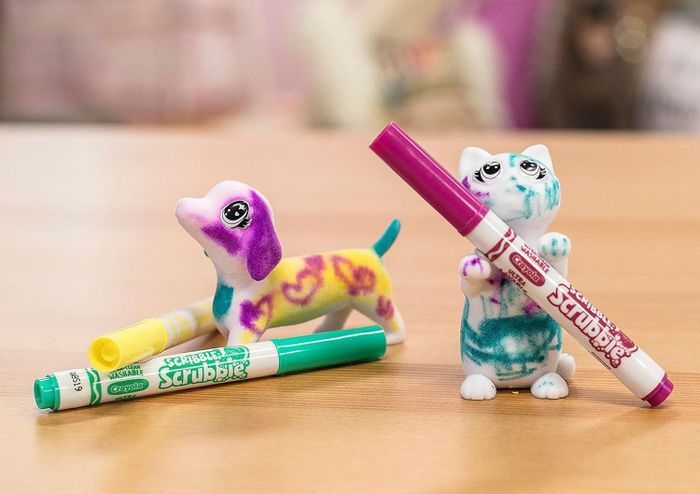 Two animals, freshly colored and sitting beside the markers, ready for more creativity.