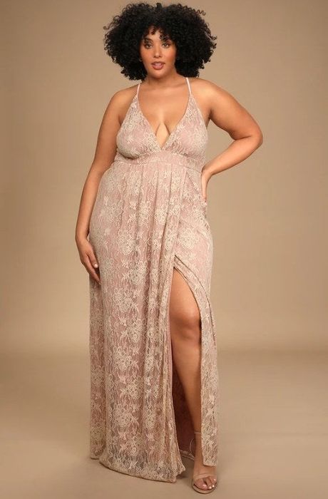 A photo of a model showcasing a blush lace-up maxi dress featuring a side slit and a deep v-neckline
