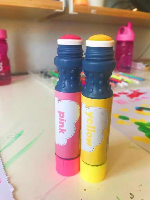 A reviewer's photo of the pink and yellow paint pens.