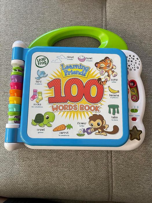 A reviewer's photo showcasing the 100 Words Book for kids.