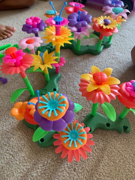 A photo shared by the reviewer showcasing colorful plastic flower toys.
