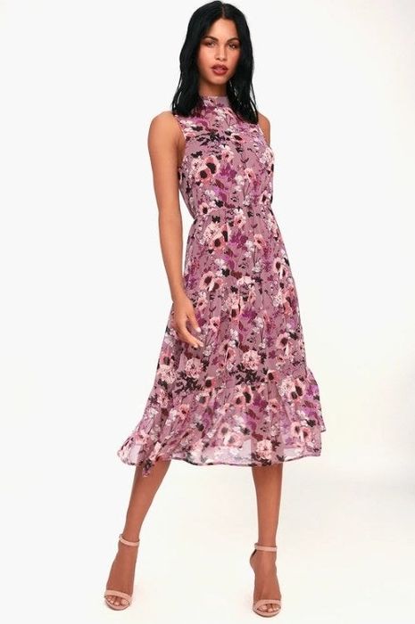 A model showcasing a floral midi dress featuring a mock collar, a keyhole back design, and button detailing at the top.