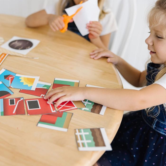 A child sorting through the materials from the activity book.