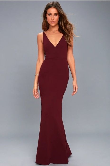 A model dressed in a stunning plum-colored sleeveless maxi dress.