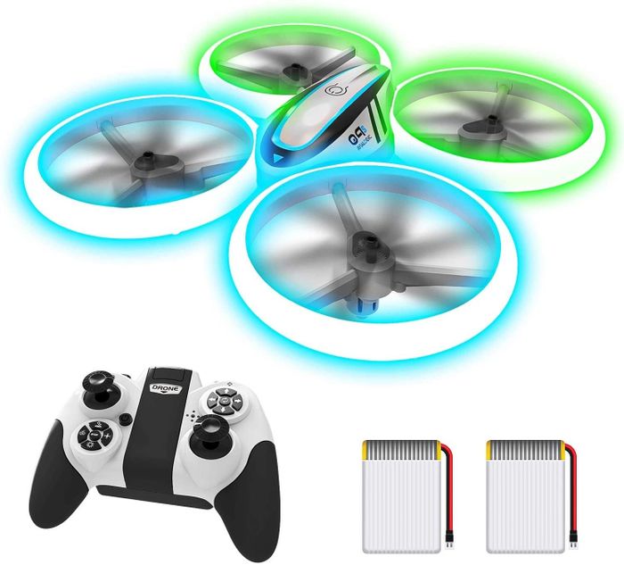 A glowing drone with its remote control and two batteries