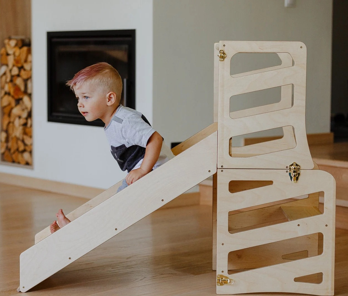 A child sliding down the slide.