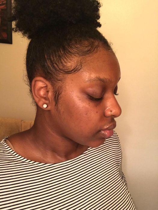 A reviewer with radiant, hydrated skin after using the spray.