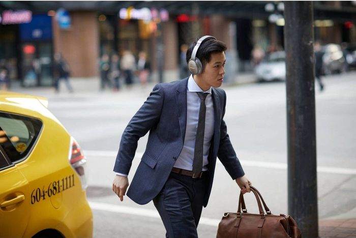 A model wearing noise-canceling headphones