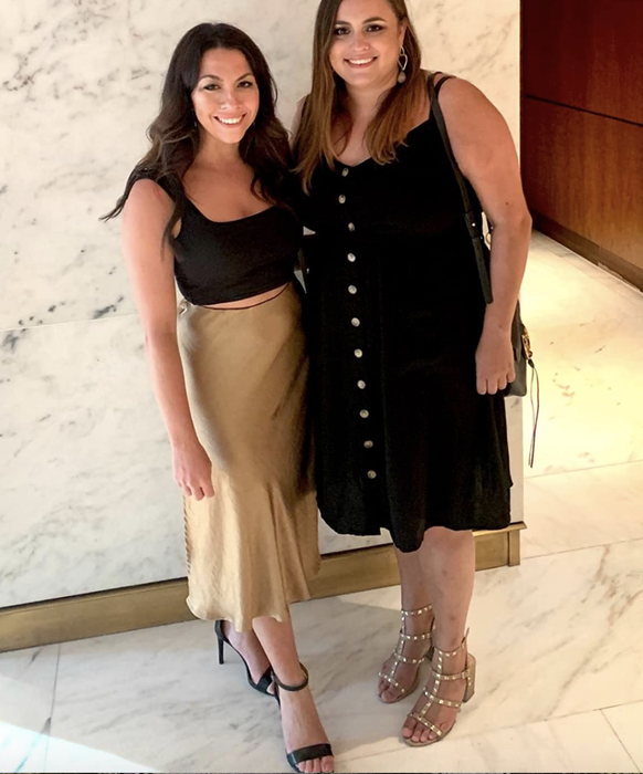 The reviewer is seen wearing an elegant gold skirt.