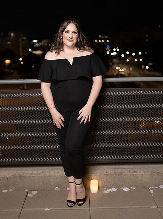 The reviewer is sporting a sleek black jumpsuit.