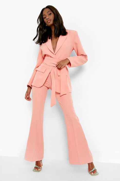 A model wearing the vibrant coral set.