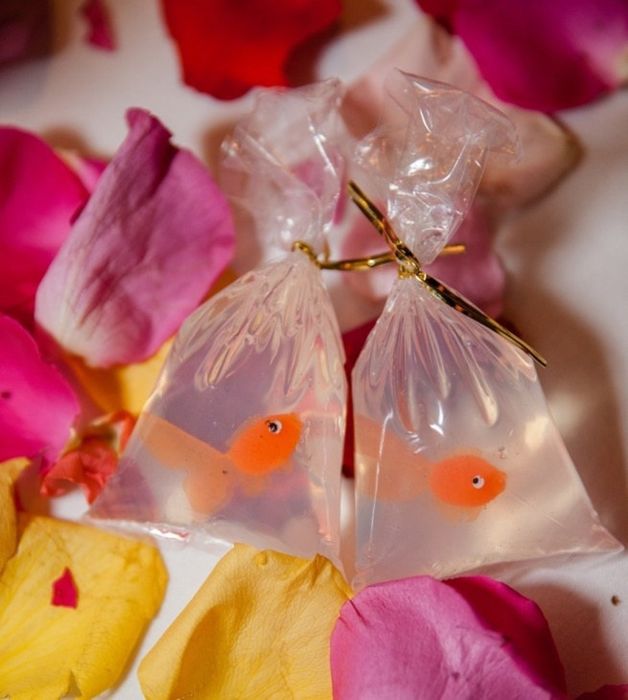 two soaps in bags, each containing a plastic goldfish inside