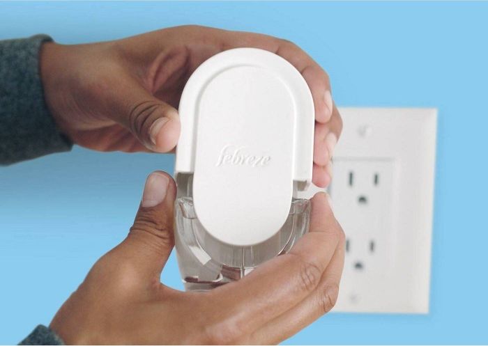 A person installing a Febreze kit.