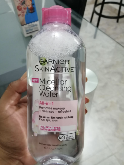 Reviewer holding the bottle of micellar water